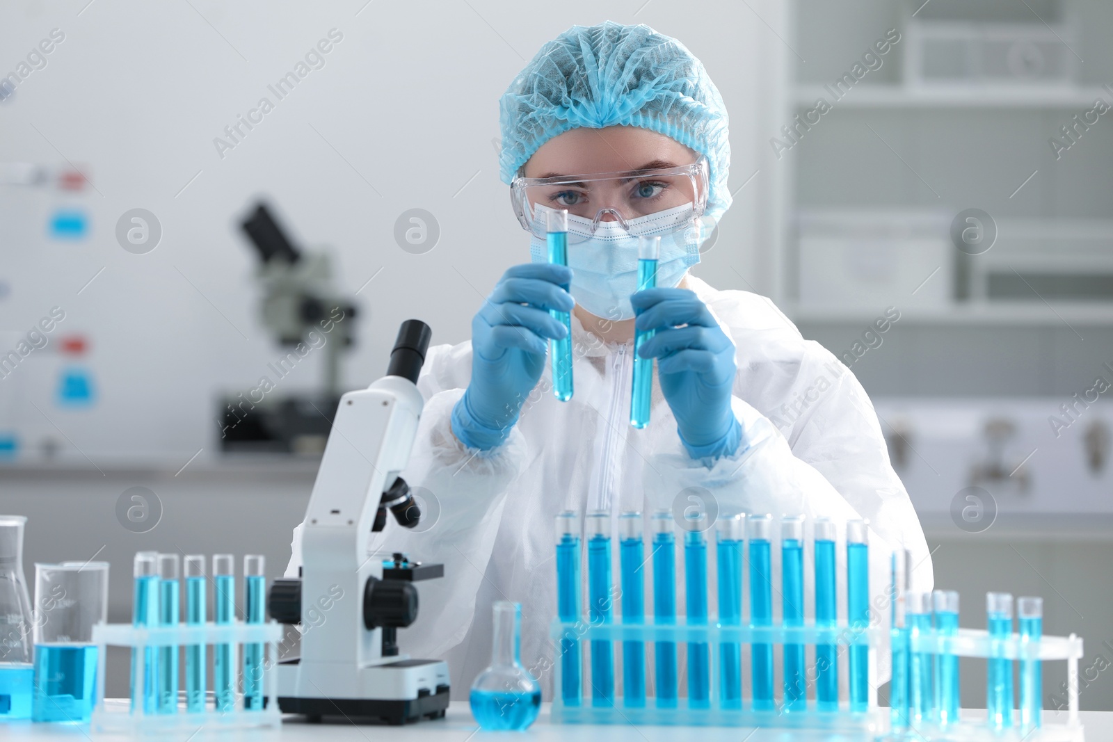 Photo of Scientist working with samples in test tubes in laboratory