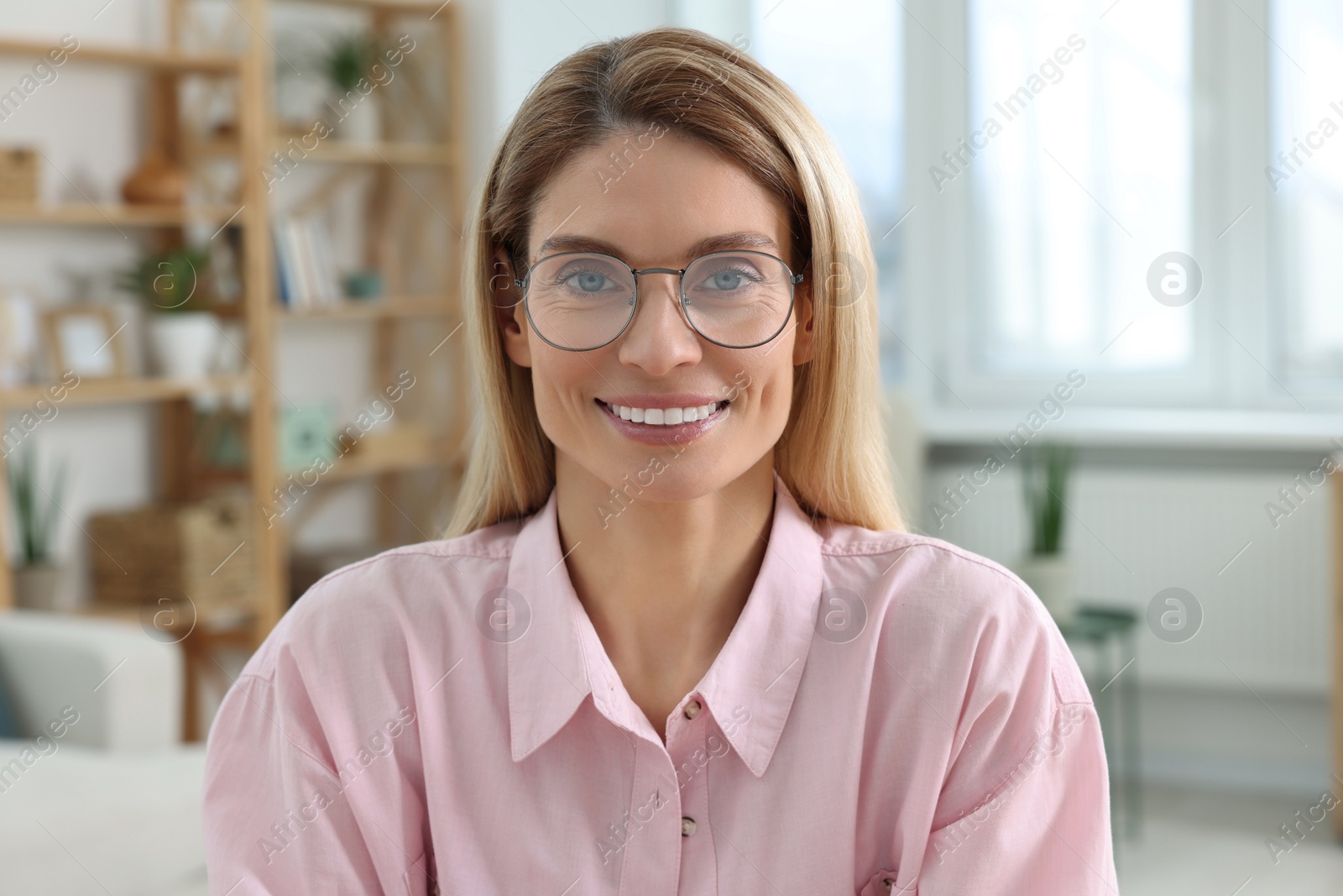 Photo of Happy woman having video call at home, view from web camera