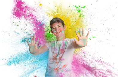 Holi festival celebration. Happy teen boy covered with colorful powder dyes on white background