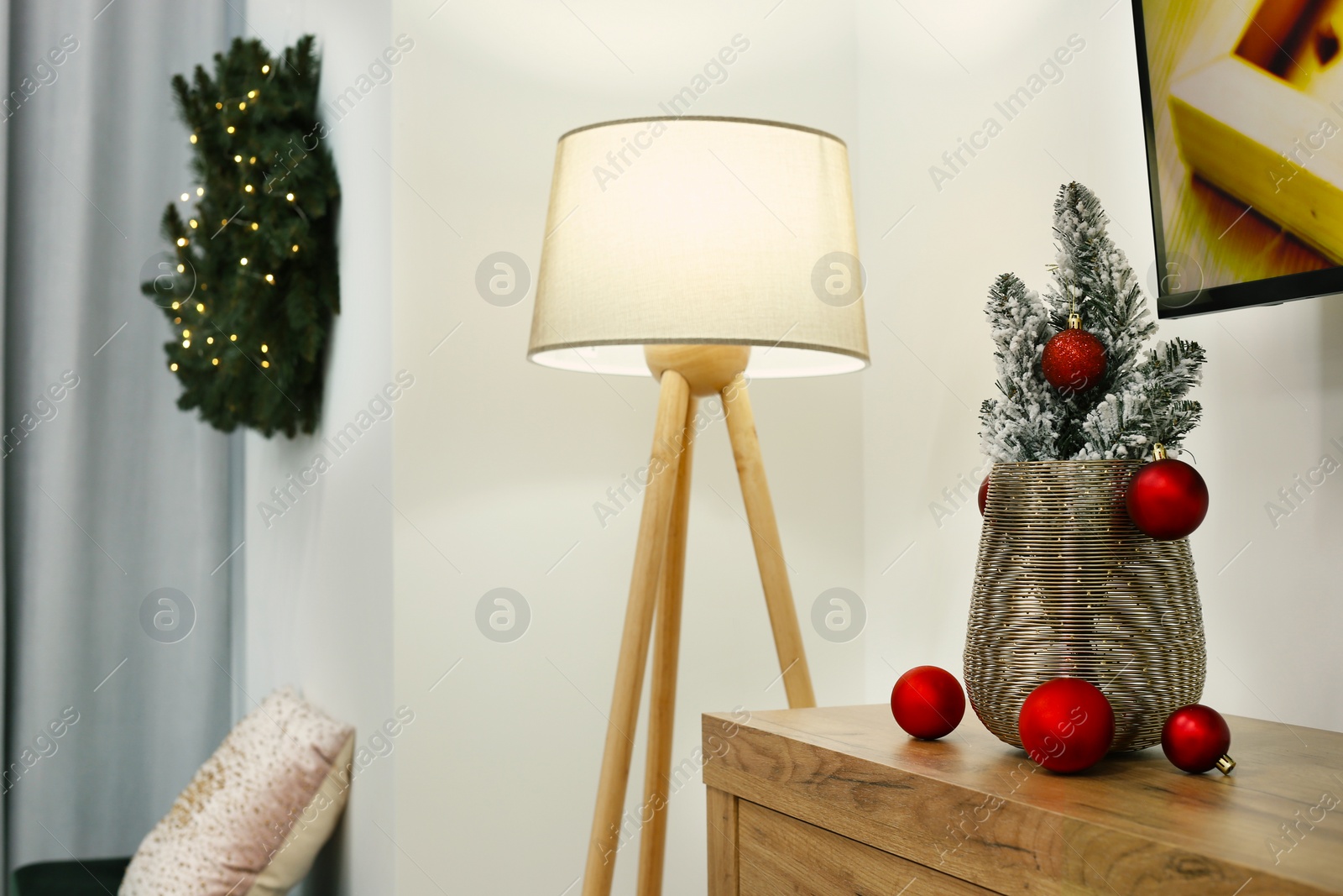 Photo of Stylish lamp and Christmas decor in room. Interior design