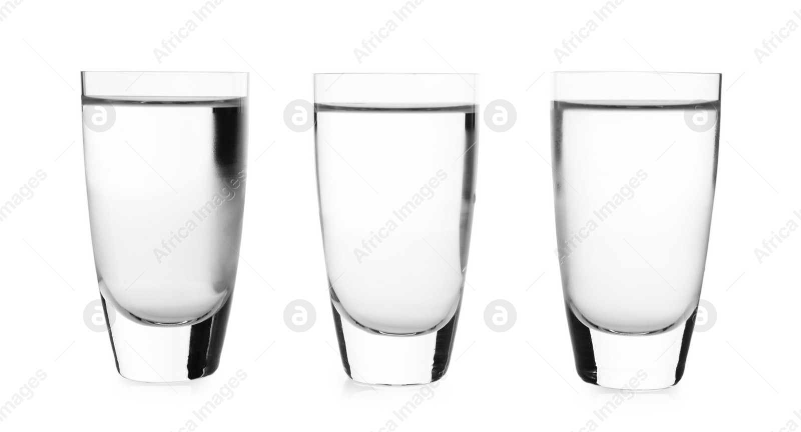 Photo of Cold vodka in shot glasses on white background