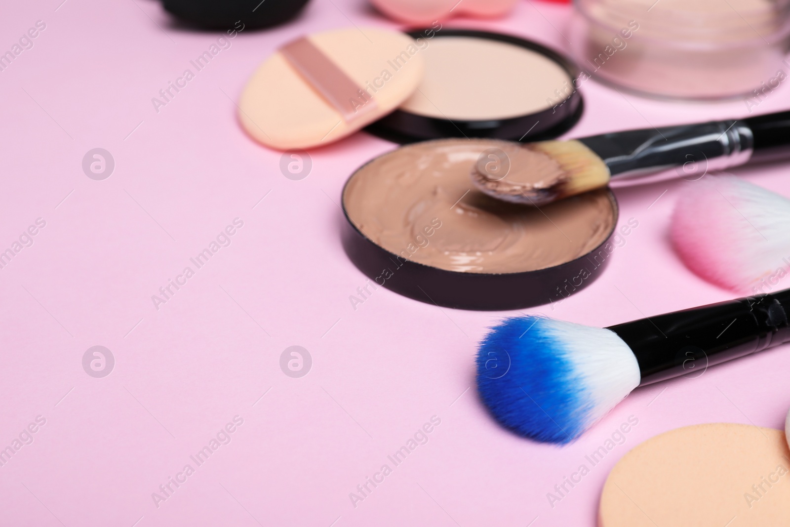 Photo of Composition with skin foundation and beauty accessories on color background. Space for text