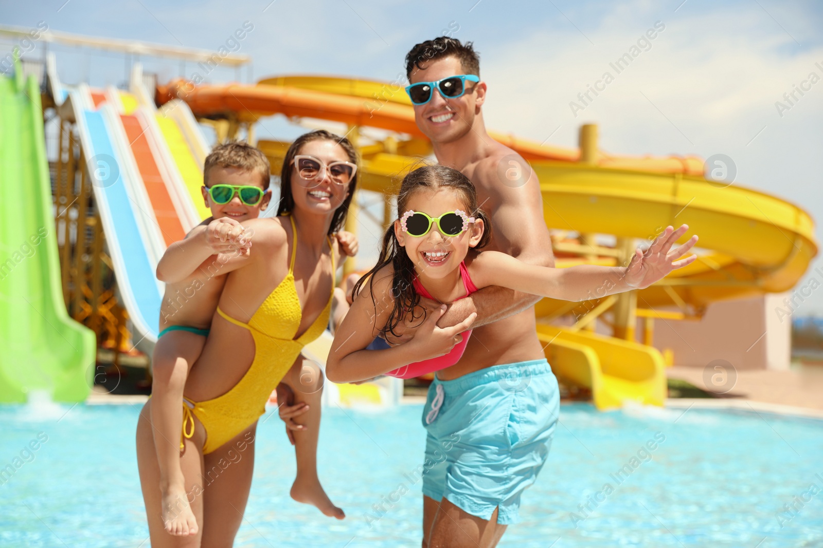 Photo of Happy family at water park. Summer vacation