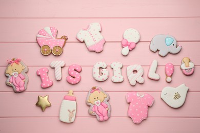 Photo of Phrase It is a girl and tasty cookies on pink background, flat lay. Baby shower party