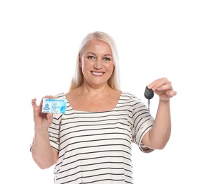 Happy mature woman with driving license and car key on white background