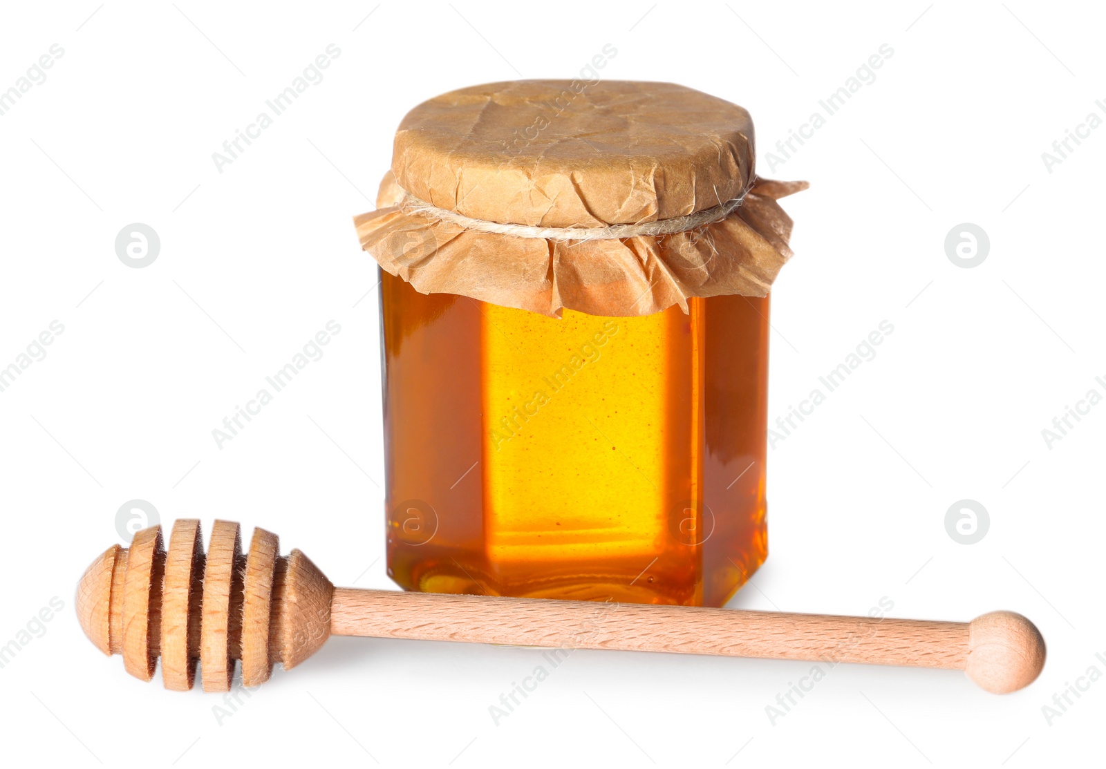 Photo of Tasty natural honey in glass jar and dipper isolated on white