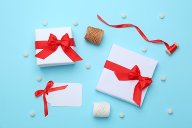 Photo of Beautiful Christmas gift boxes with ribbons and decors on color background, top view