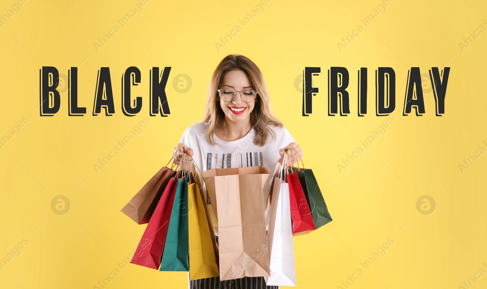 Image of Black Friday Sale. Beautiful young woman with shopping bags on yellow background