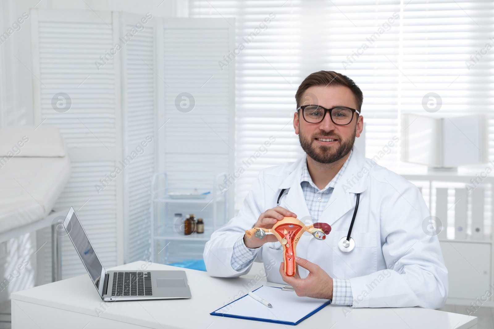 Photo of Gynecologist demonstrating model of female reproductive system in clinic