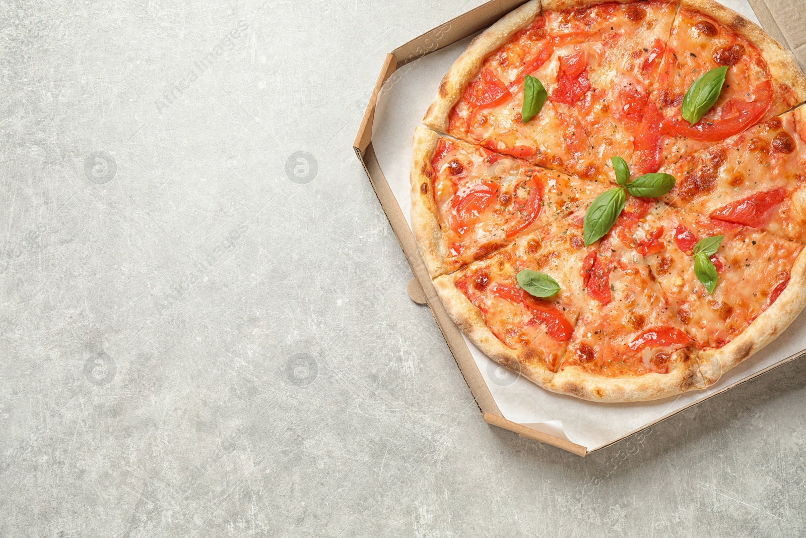 Photo of Delicious pizza Margherita on light grey table, top view. Space for text