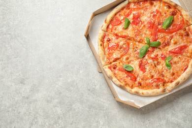 Photo of Delicious pizza Margherita on light grey table, top view. Space for text