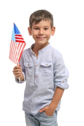 Photo of Portrait of cute little boy with American flag on white background