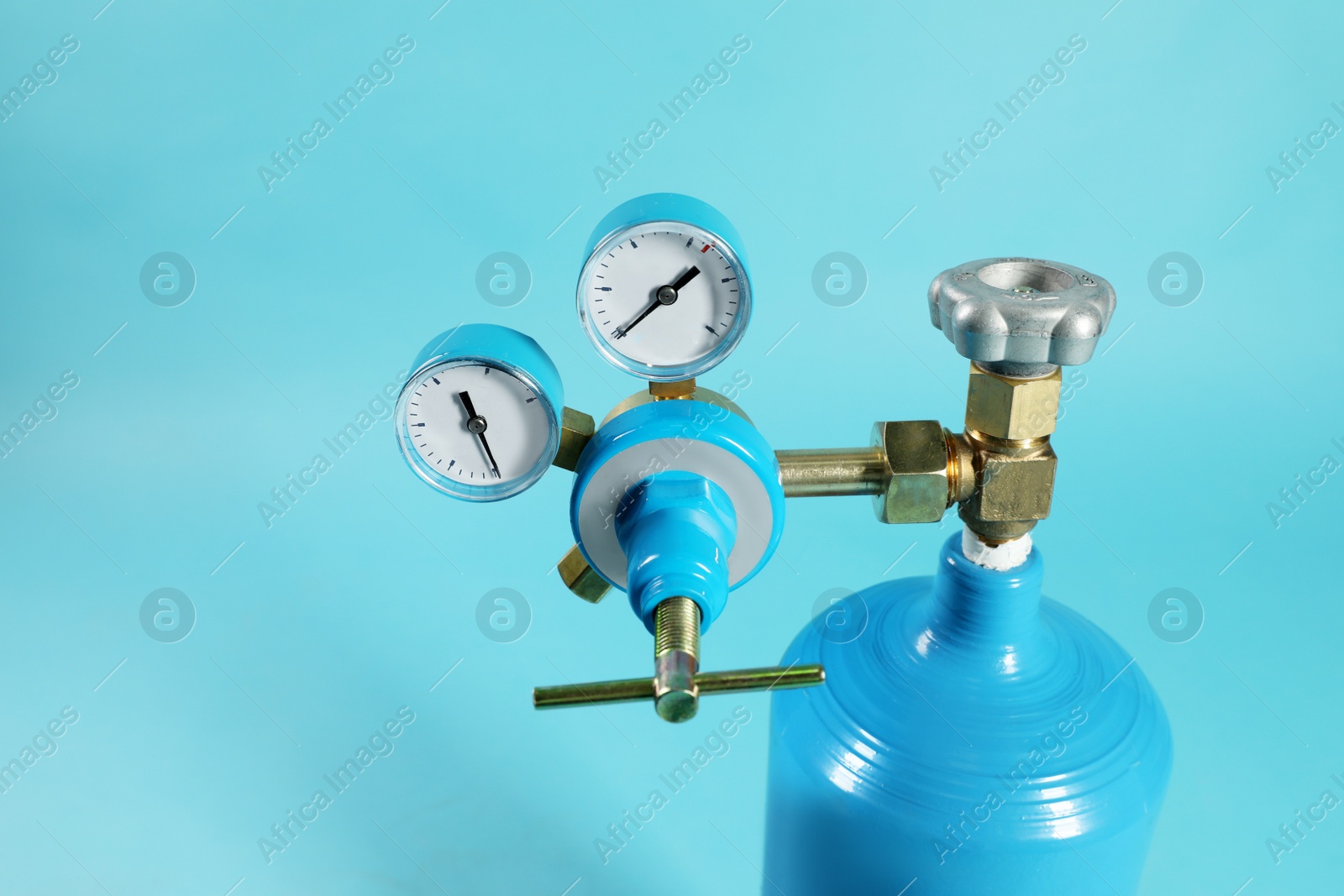 Photo of Oxygen tank on light blue background, closeup. Medical equipment