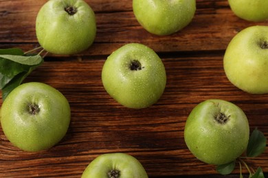 Photo of Fresh ripe green apples with water drops on wooden table