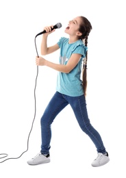 Photo of Cute girl singing in microphone on white background