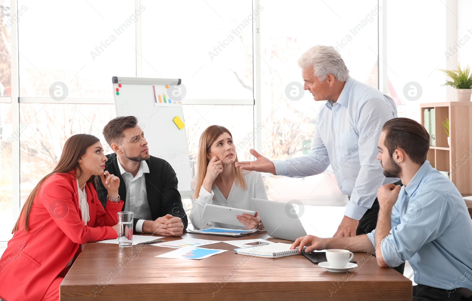 Photo of Office employees having argument during business meeting