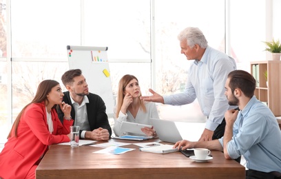 Office employees having argument during business meeting