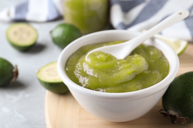 Feijoa jam and fruit on light table, closeup