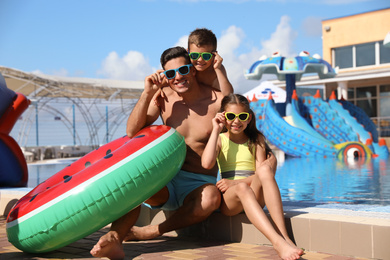 Photo of Man with his children at water park. Summer vacation