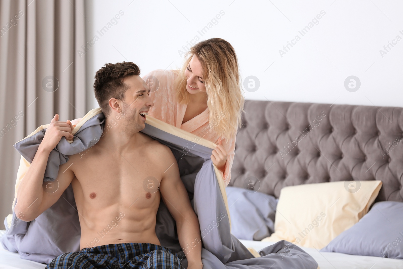 Photo of Lovely young couple on bed at home