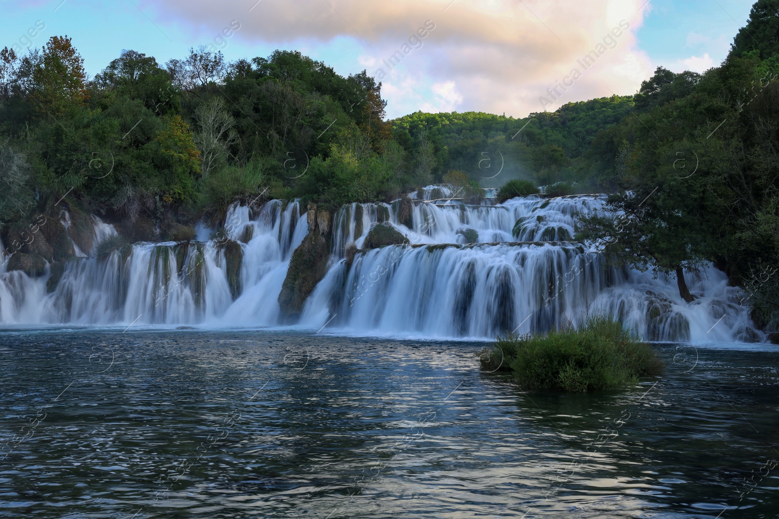 Photo of Picturesque view of beautiful waterfall and rocks outdoors