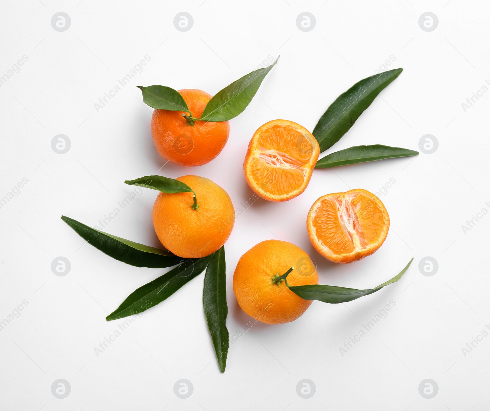 Photo of Fresh ripe tangerines with green leaves on white background, top view