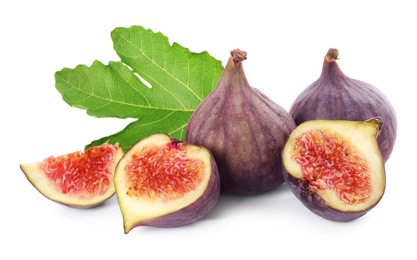 Photo of Tasty whole and cut figs with green leaf isolated on white