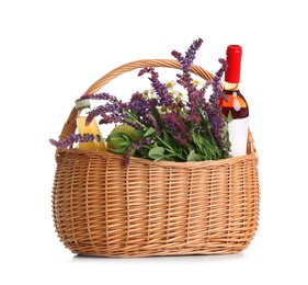 Photo of Picnic basket with flowers and wine isolated on white