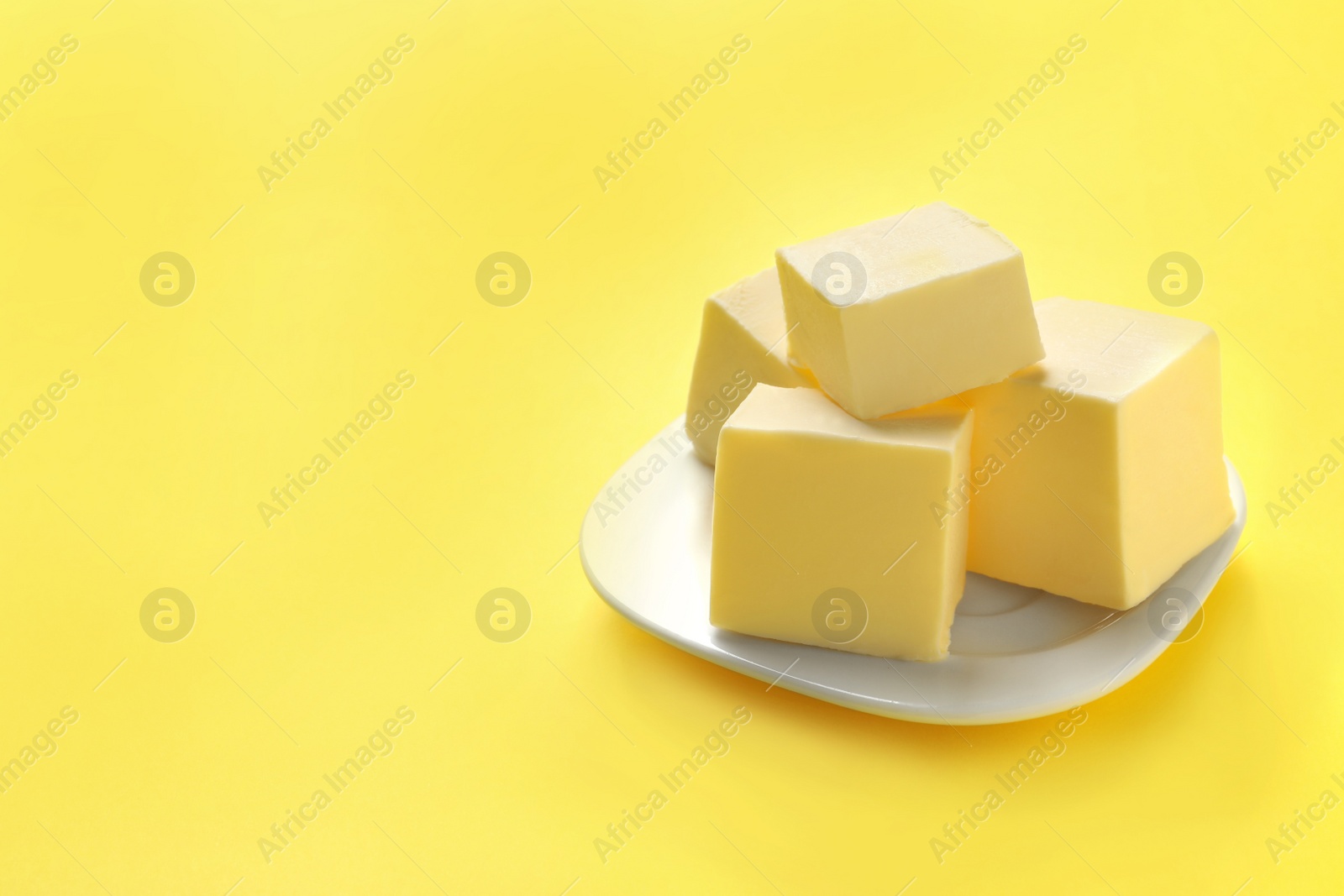 Photo of Plate with fresh butter on color background. Space for text