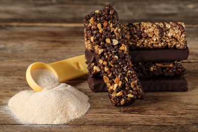 Photo of Different tasty bars and protein powder on wooden table