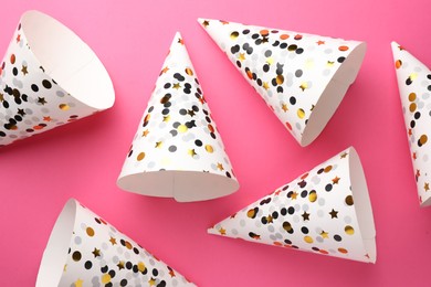 Photo of Beautiful party hats on pink background, top view