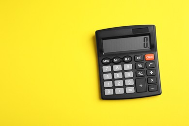 Photo of Calculator on yellow background, top view. Space for text