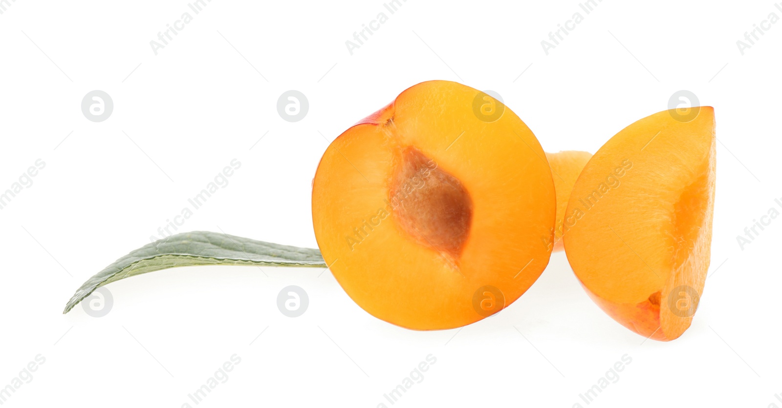 Photo of Cut ripe plum with leaf isolated on white