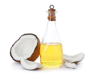 Ripe coconut and bottle with oil on white background. Healthy cooking