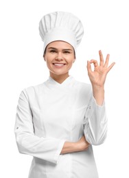 Photo of Happy female chef showing ok gesture on white background