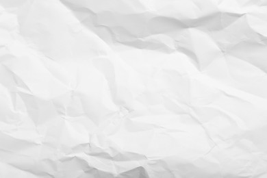 Photo of Sheet of white crumpled paper as background, closeup