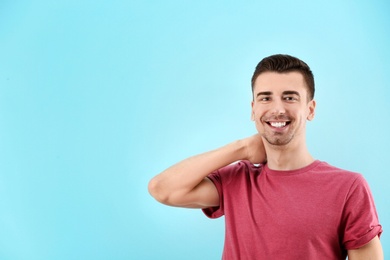 Charming young man on color background