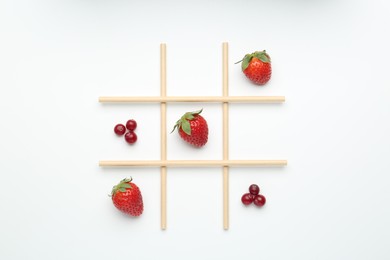 Photo of Tic tac toe game made with berries isolated on white, top view