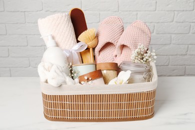 Photo of Spa gift set in wicker basket on white marble table