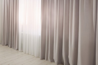 Light grey window curtains and white tulle indoors