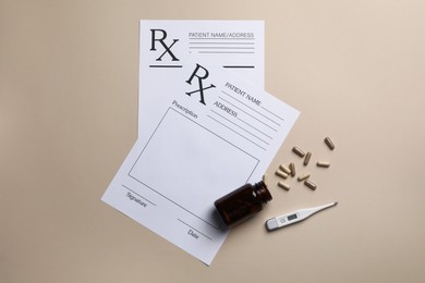 Photo of Medical prescription forms, pills and thermometer on beige background, flat lay