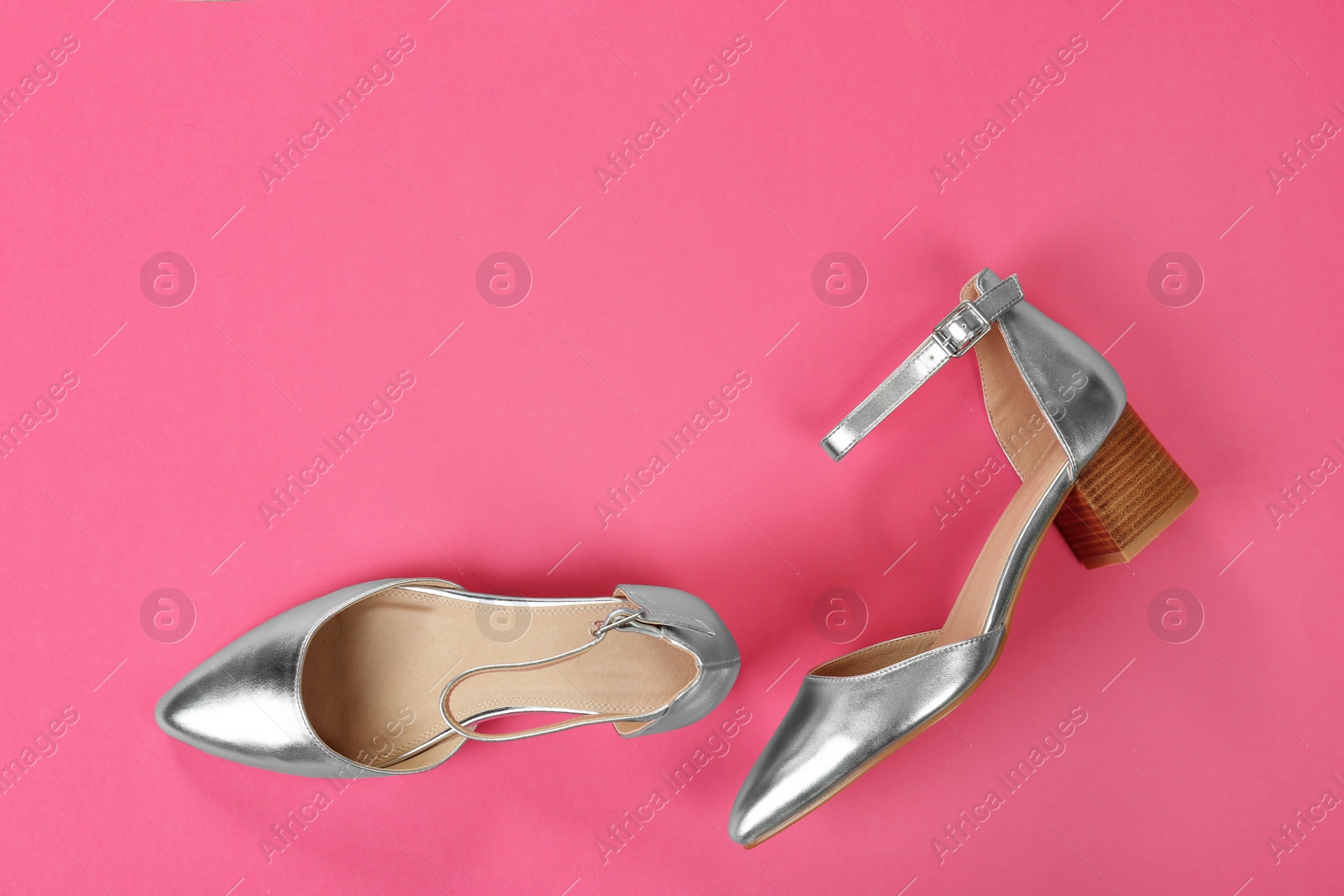 Photo of Pair of female shoes on color background, top view