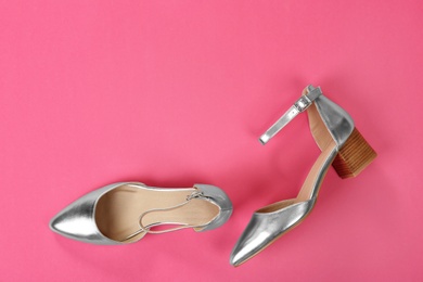 Photo of Pair of female shoes on color background, top view