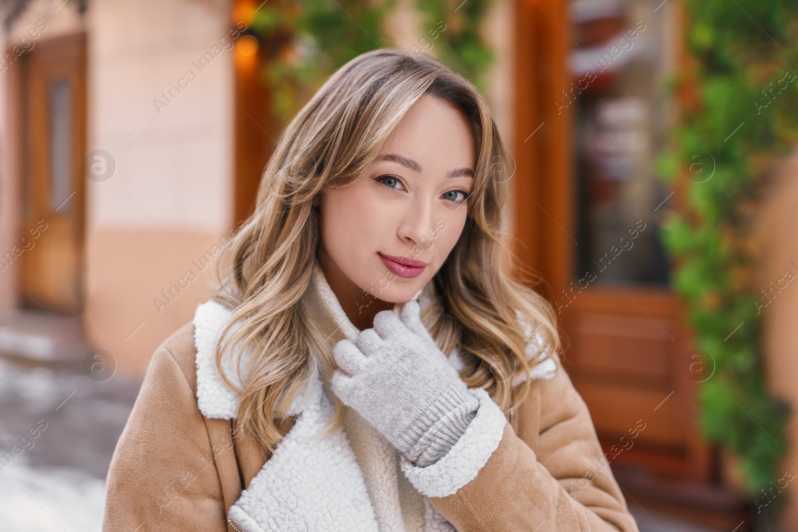 Photo of Portrait of charming woman on city street in winter