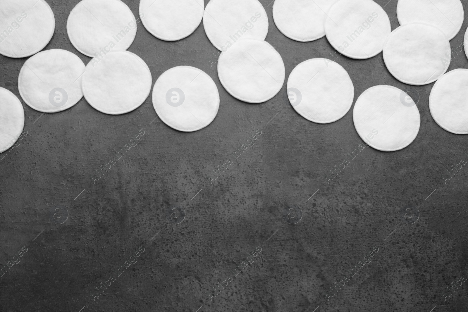 Photo of Many clean cotton pads on grey background, flat lay. Space for text