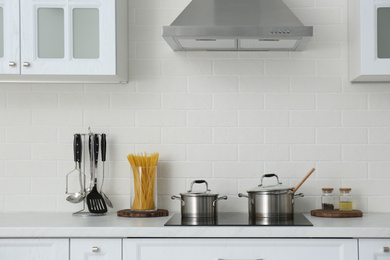 Photo of Counter with set of dishware and utensils in stylish kitchen interior