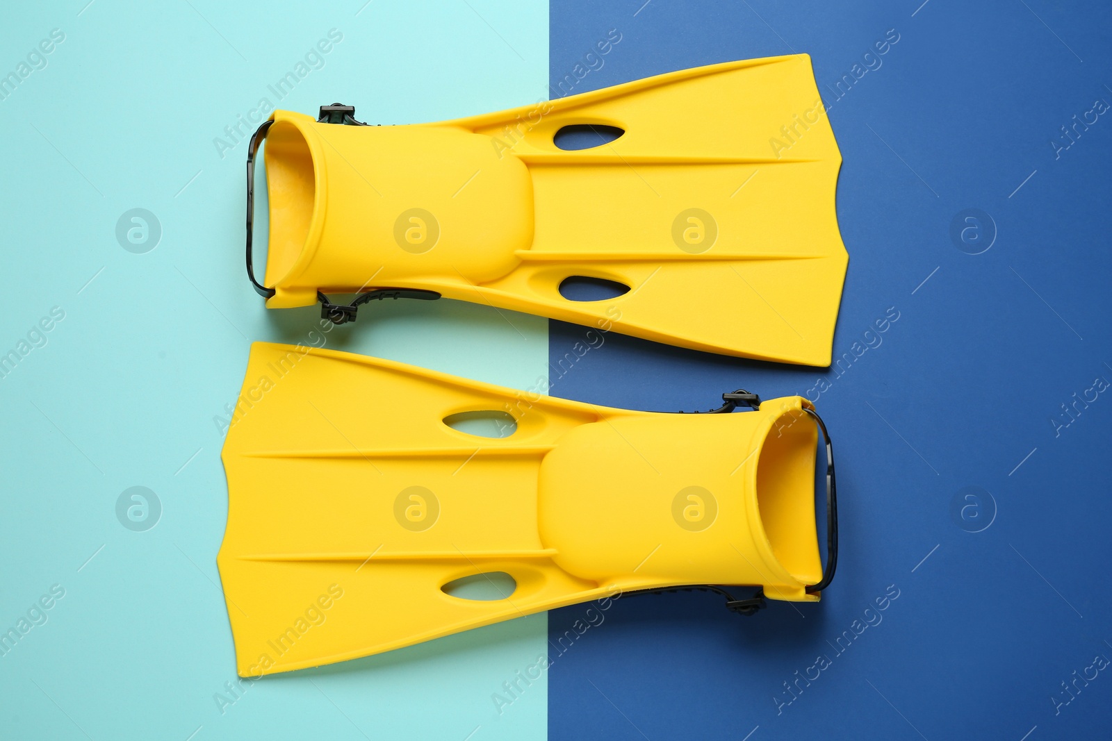 Photo of Pair of yellow flippers on color background, flat lay