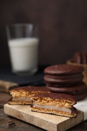 Photo of Tasty choco pies on wooden table. Space for text