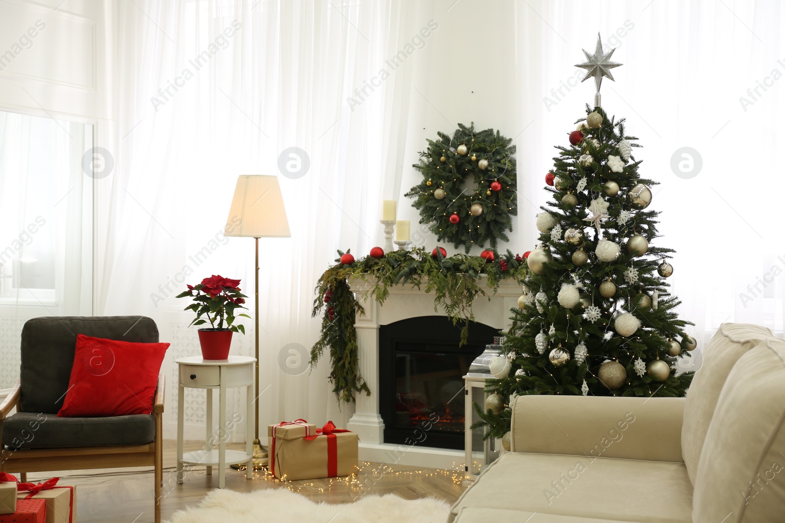 Photo of Beautiful Christmas tree with star topper in decorated room