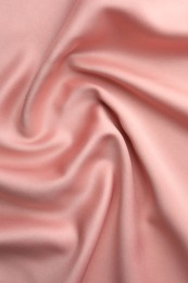 Photo of Crumpled pink silk fabric as background, top view